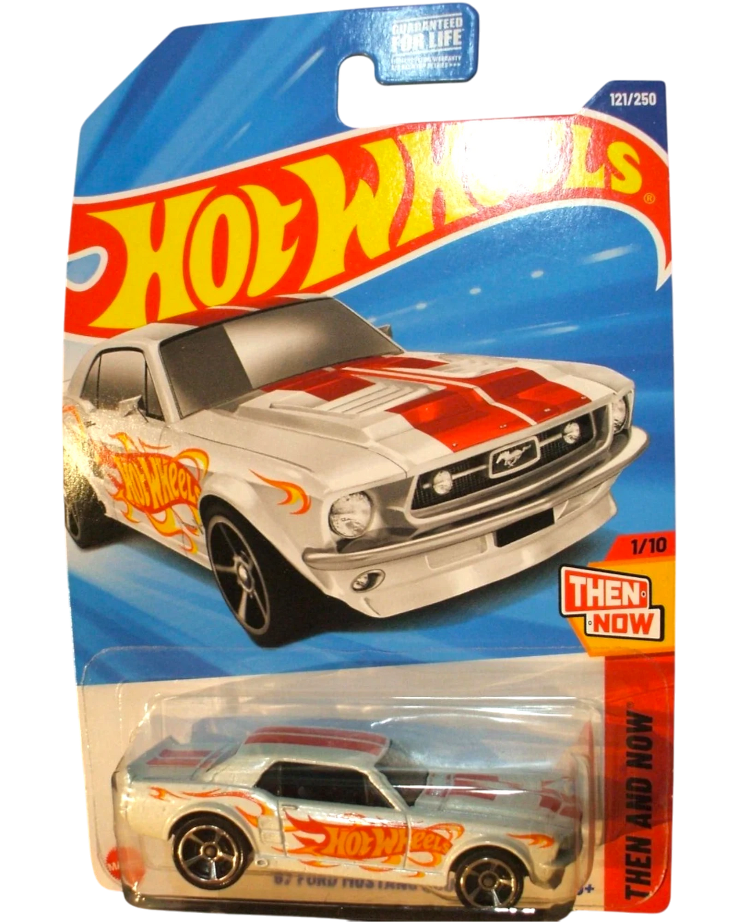 More Than Diecast 1967 white Ford Mustang coupe Hot Wheels diecast car with red racing stripes and flame graphics.