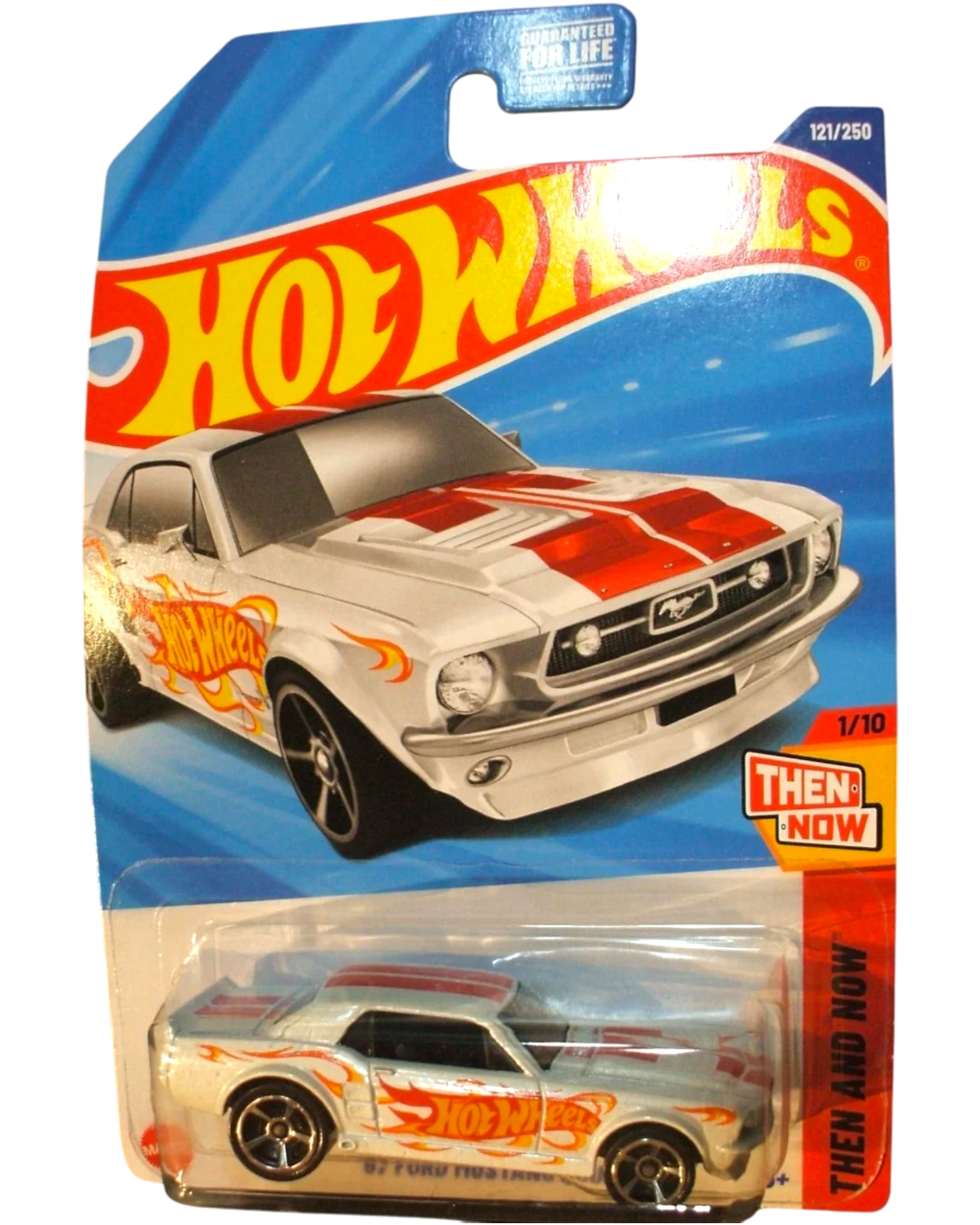 More Than Diecast 1967 white Ford Mustang coupe Hot Wheels diecast car with red racing stripes and flame graphics.
