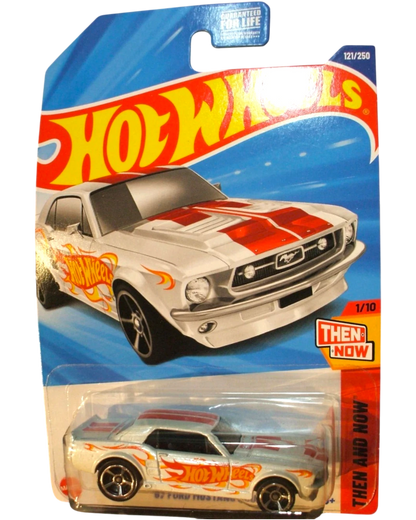 More Than Diecast 1967 white Ford Mustang coupe Hot Wheels diecast car with red racing stripes and flame graphics.