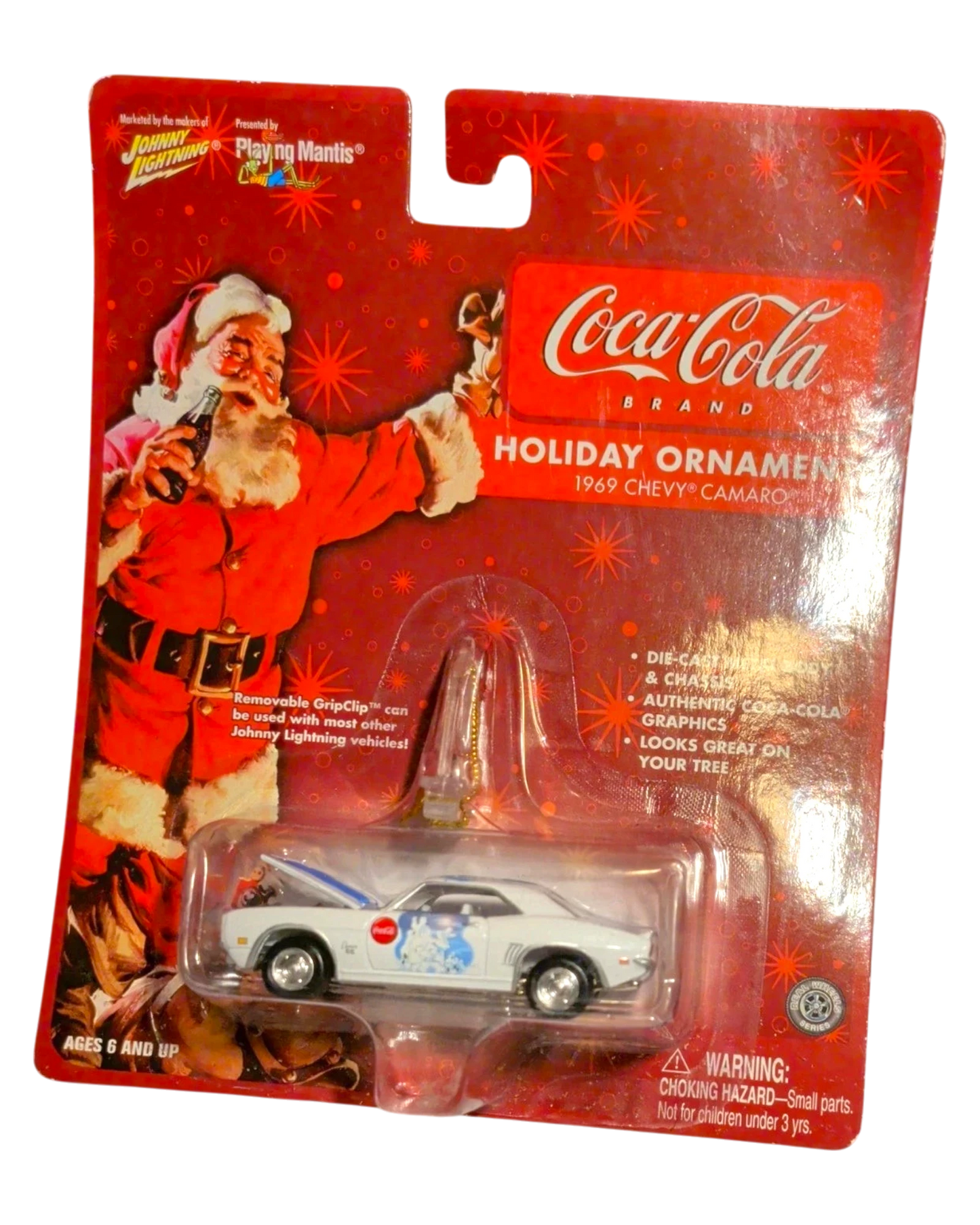 More Than Diecast Coca-Cola 1969 Chevy Camaro holiday ornament. White die-cast car with blue stripes and Coca-Cola graphics, featuring Santa Claus.