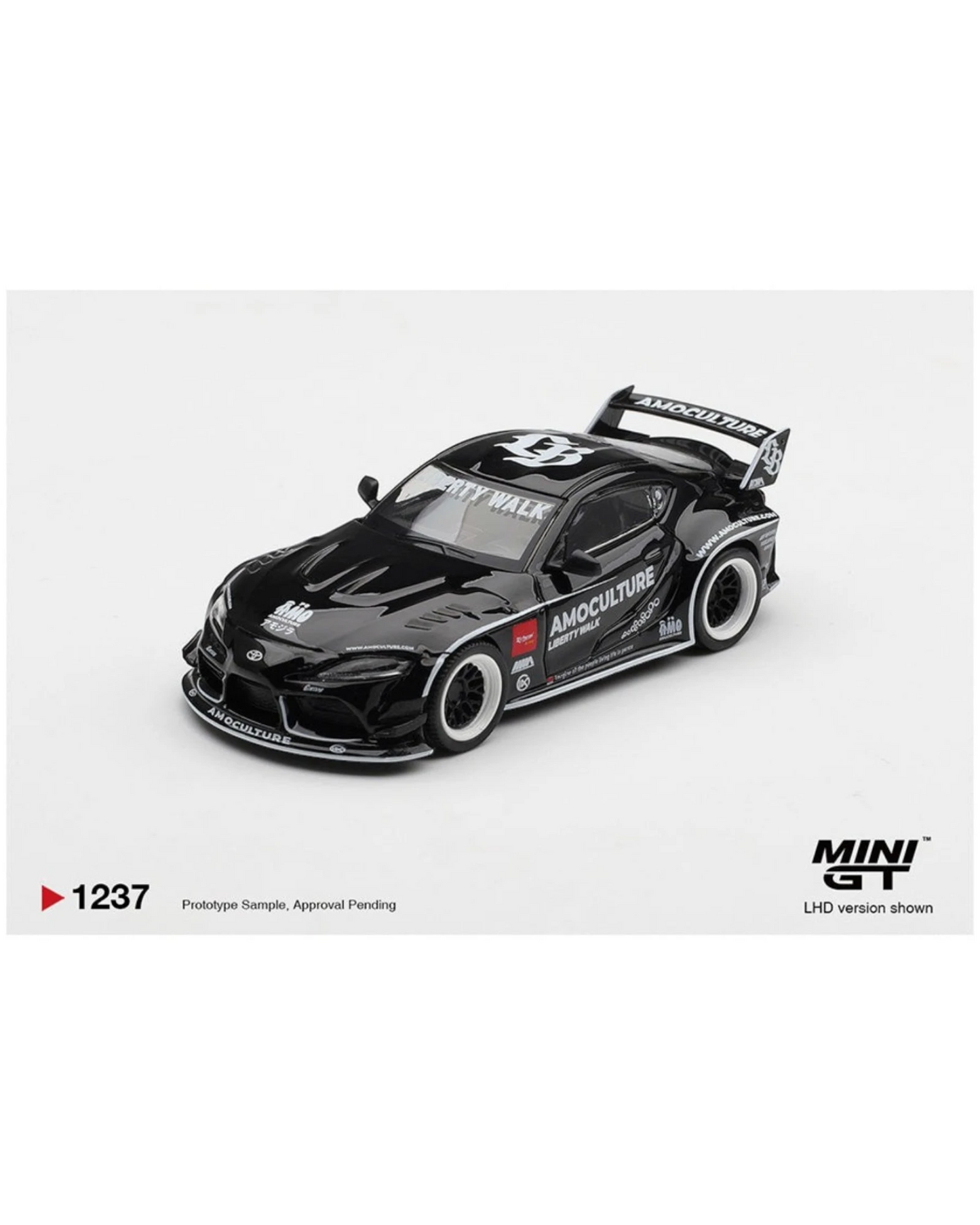 More Than Diecast 1:64 black Toyota GR Supra LB Works AMOCULTURE die-cast model with wide-body kit and racing livery.