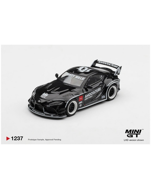 More Than Diecast 1:64 black Toyota GR Supra LB Works AMOCULTURE die-cast model with wide-body kit and racing livery.