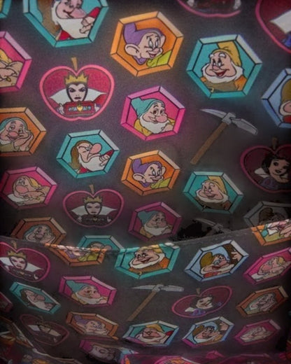 More Than Diecast Disney Snow White mini backpack with a print of the Seven Dwarfs in hexagonal frames and the Evil Queen in an apple frame.