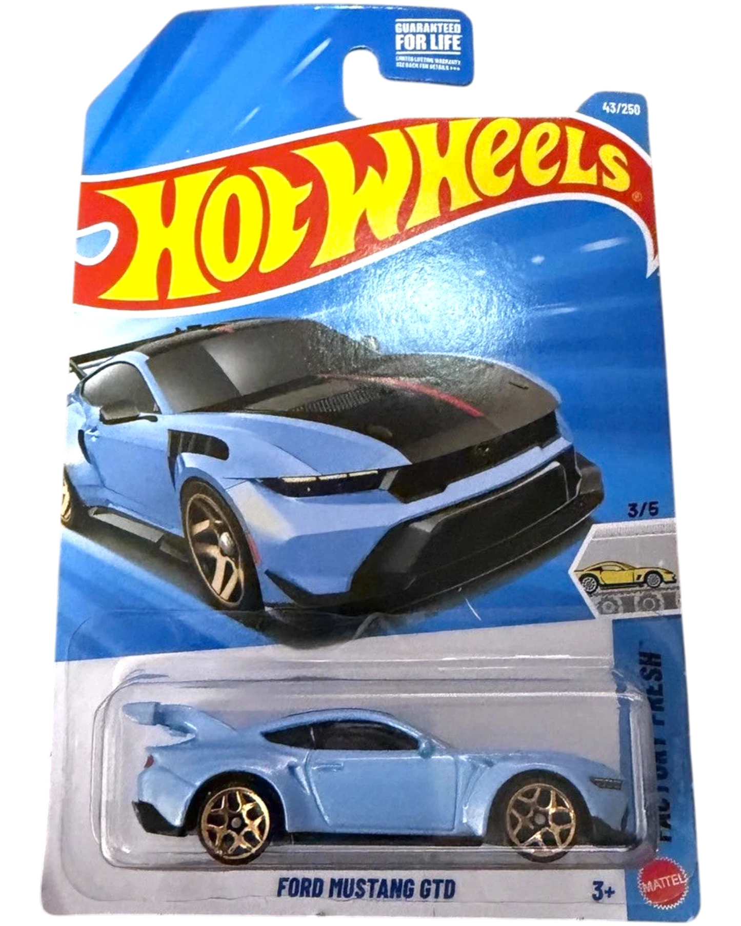 More Than Diecast 2026 Hot Wheels Ford Mustang GTD in light blue with black accents and gold wheels, displayed in packaging.