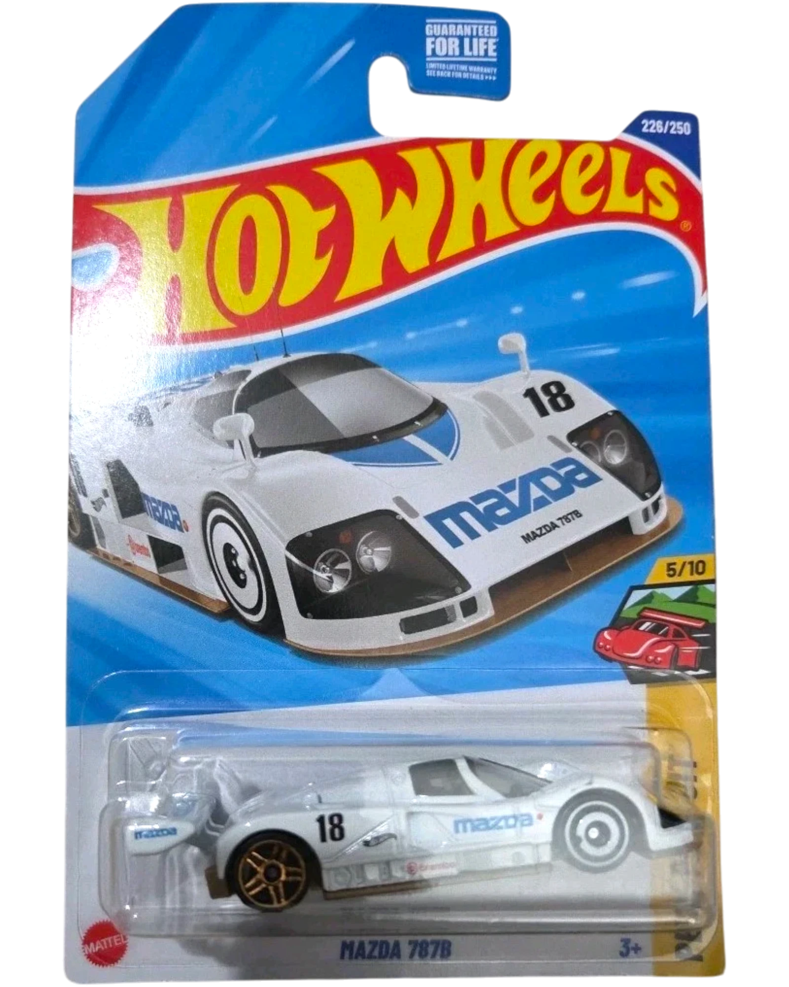 More Than Diecast Hot Wheels 2025 Mazda 787B LeMans race car, white with blue accents and #18. Diecast model in packaging.