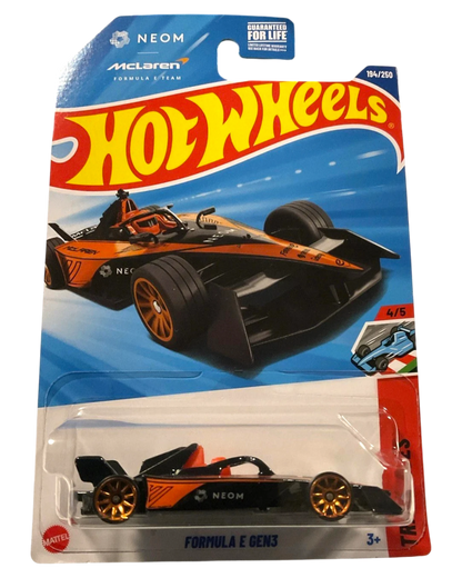 More Than Diecast 2025 Hot Wheels Neom McLaren Formula E GEN3 die-cast car, black with orange accents and gold wheels.