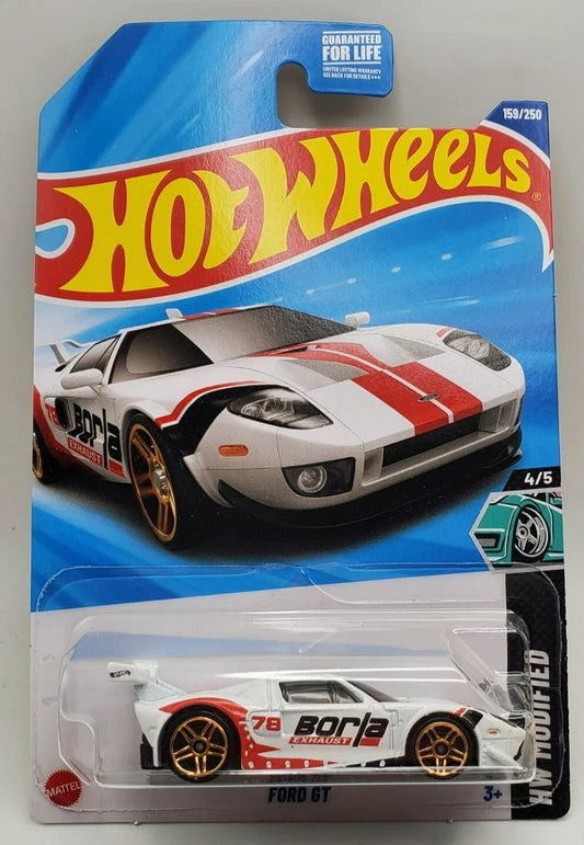 More Than Diecast Hot Wheels White Ford GT HW Modified diecast model car with red racing stripes and gold wheels.