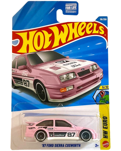 More Than Diecast 2026 Hot Wheels '87 Ford Sierra Cosworth in pink with white racing stripes and '87 graphics. 1:64 scale die-cast.