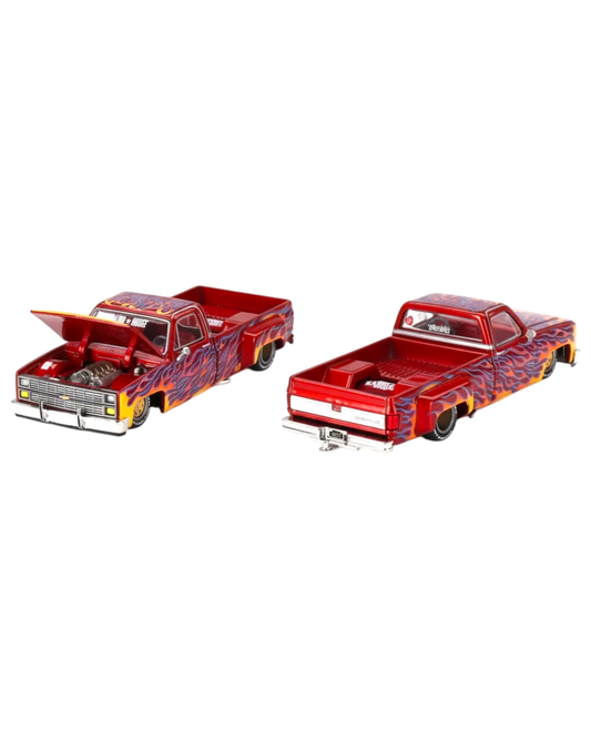 Two model trucks with flame design on a white background, featuring Kaido House Mini GT branding.