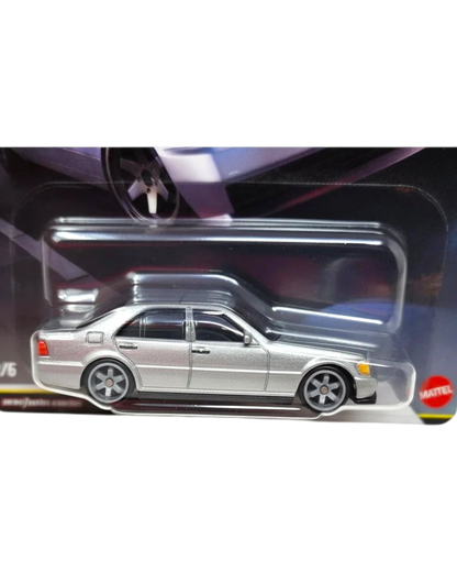 Silver die-cast car model in packaging with a visible Mattel logo.